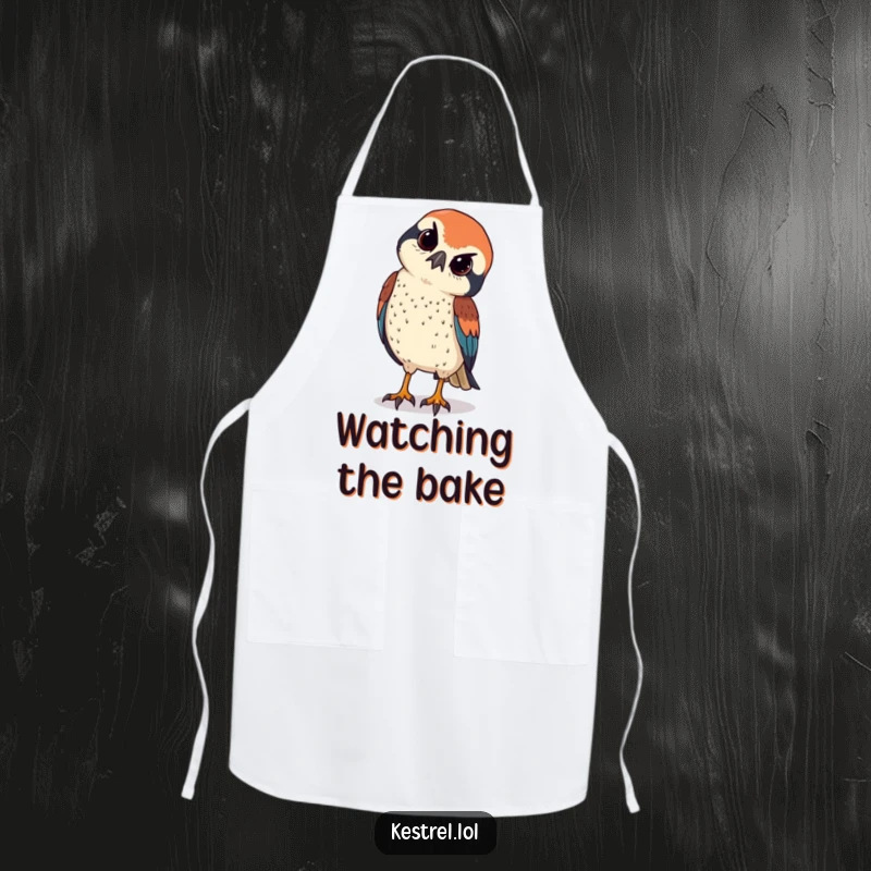 Funny kestrel tilts its head curiously, sharp eyes observing below, on a chef's apron.