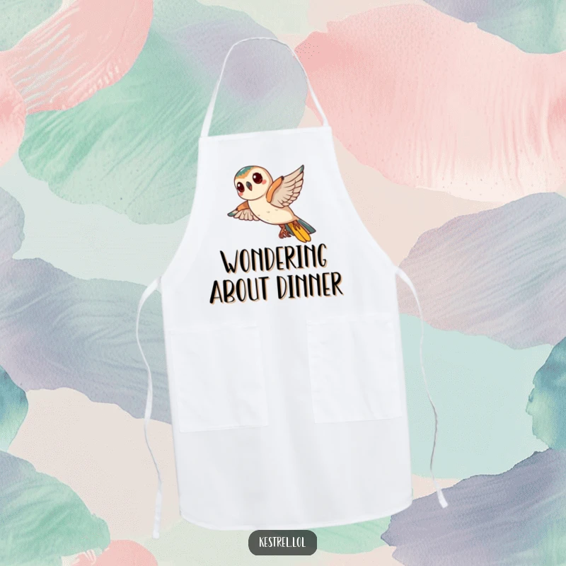 Funny Kestrel Apron: A curious kestrel tilts its head mid-flight while wearing an apron, humorously investigating recipes.