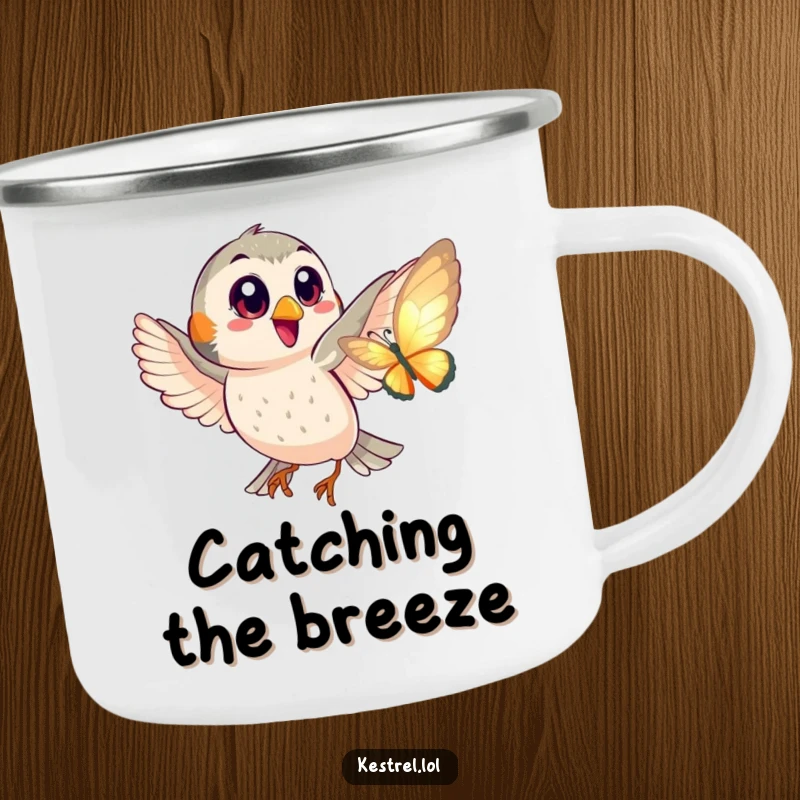 Funny camping mug showing a happy kestrel with big eyes playfully chasing a shimmering butterfly, ideal for outdoor fun.
