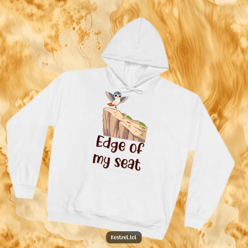 Funny focused kestrel hoodie showing a kestrel character landing gracefully on a cliff edge, offering comfort and focus.