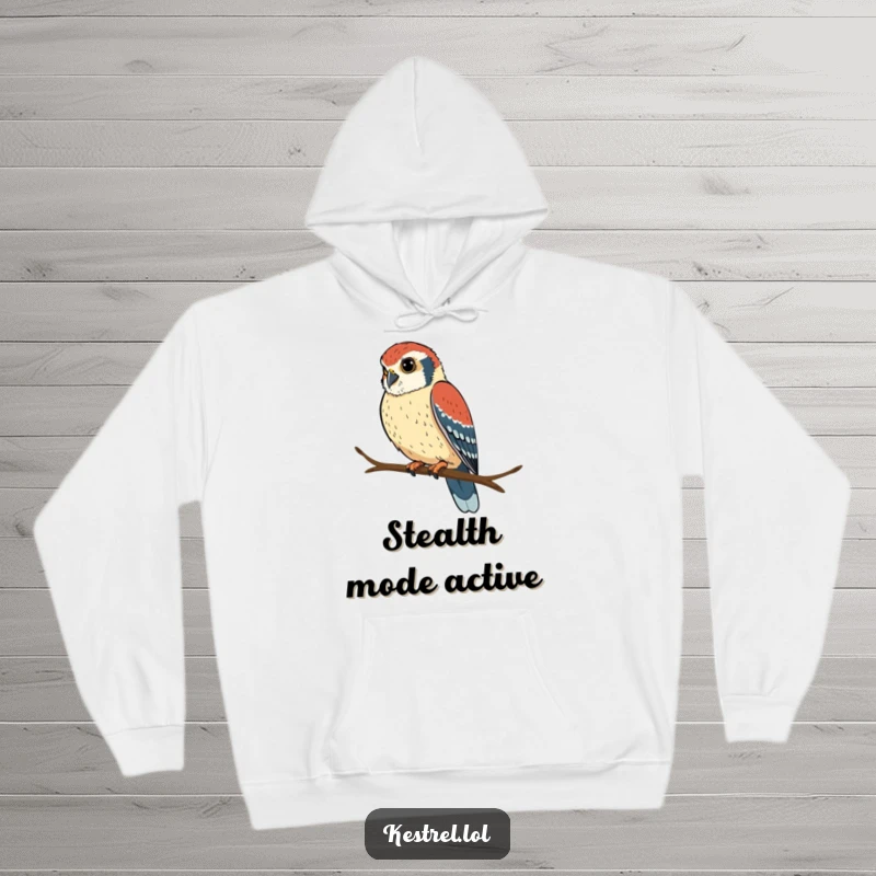 Funny kestrel hoodie showing a determined bird perched on a branch, looking intently, offering warmth and focus.