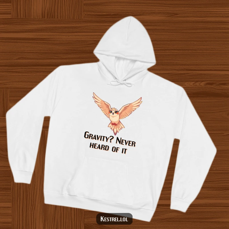 Funny kestrel hoodie depicting a kestrel character gliding with ease on air currents, capturing the joy of flight.