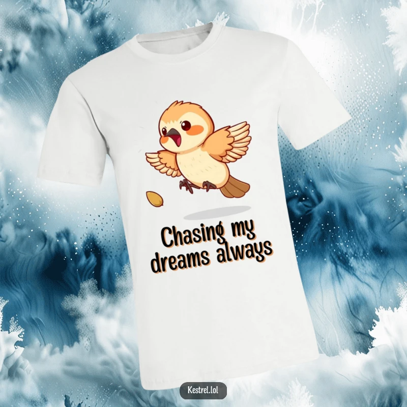 Funny Kestrel T-Shirt: A playful kestrel is shown mid-air, excitedly chasing a small bouncing seed with great determination.