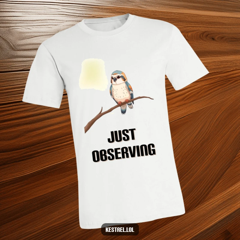 Funny kestrel t-shirt featuring a curious bird perched on a thin branch, looking around with interest.