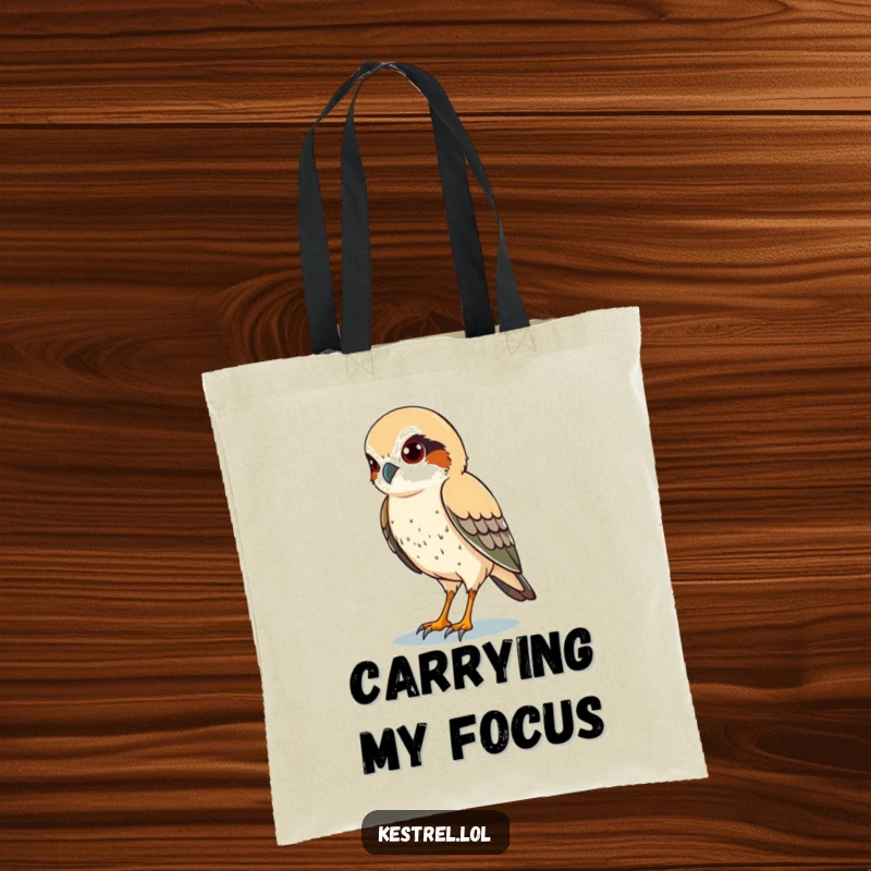 Funny tote bag featuring a kestrel character with sharp eyes, scanning the ground below, symbolizing vigilance.