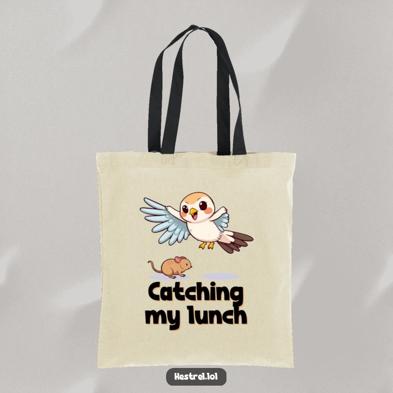 Funny tote bag illustrating a cartoon kestrel comically swooping down with outstretched wings, aiming for a tiny mouse.