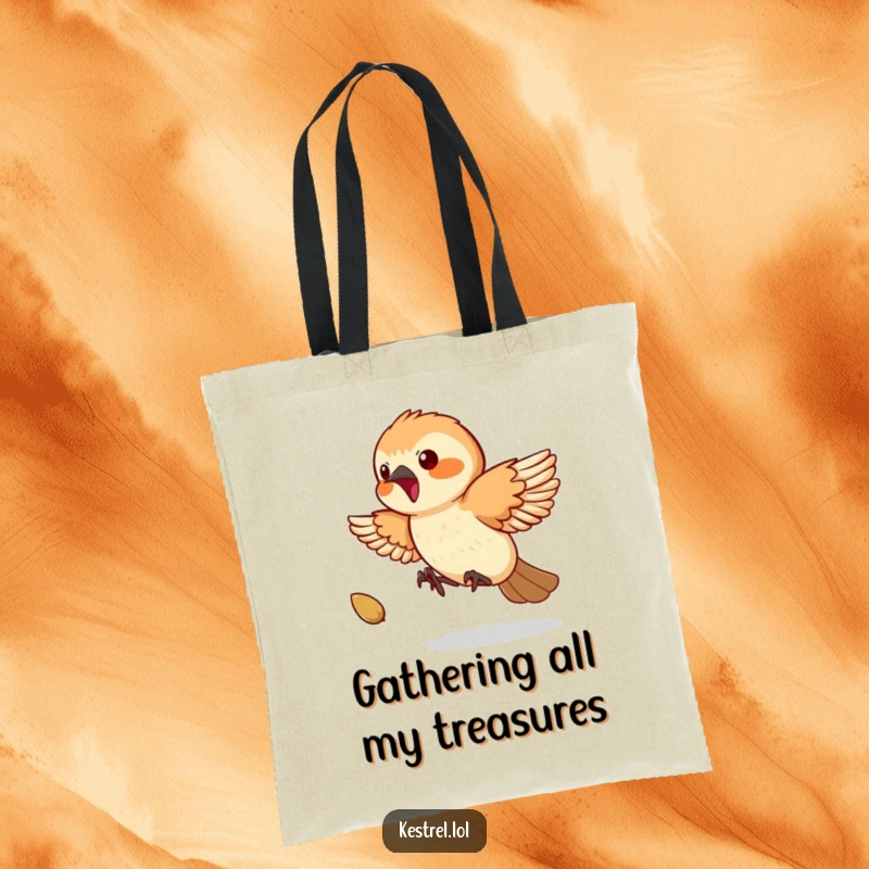 Funny Kestrel Tote Bag: A playful kestrel is humorously depicted chasing a small bouncing seed with great enthusiasm.