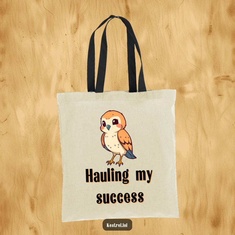 Funny kestrel tote bag with a smiling bird squinting its eye in a hunting pose, ideal for carrying items humorously.